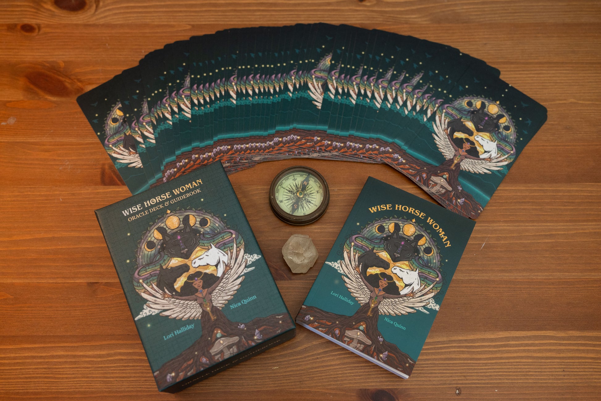Wise Horse Women tarot cards on a wooden surface with a compass and crystal.